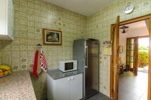 a kitchen with a refrigerator and a microwave on a counter at Club Villamar - Aygo in Maçanet de la Selva