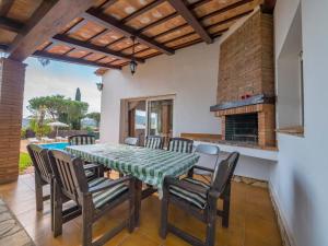 a dining room with a table and chairs and a fireplace at Club Villamar - Perdiu in Sant Feliu de Guixols