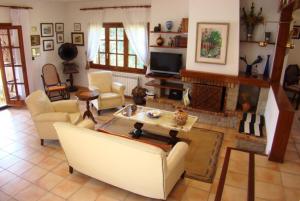 a living room with a couch and a fireplace at Club Villamar - Quietud in Santa Cristina d'Aro