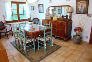 a dining room with a glass table and chairs at Club Villamar - Quietud in Santa Cristina d'Aro