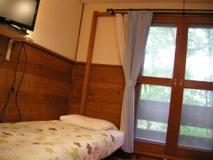 Postel nebo postele na pokoji v ubytování Hayashi Pension
