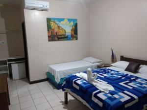 Una cama o camas en una habitación de Pousada Planeta Guarajuba