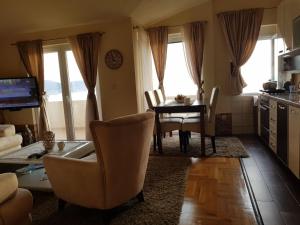 a kitchen and living room with a table and chairs at Villa Jupok in Bar