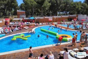 a group of people in a pool at a water park at Experience Internacional Salou - Climatizado con piscina in Salou