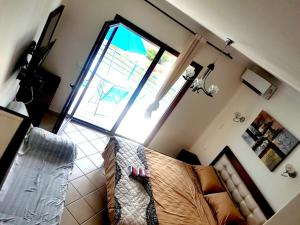 a living room with a couch and a window at Appartement hôtel cabo dream in Cabo Negro