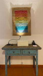 a desk with a colorful painting on the wall at Quinta do Lago Golf in Quinta do Lago
