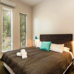 a bedroom with a large bed with two pillows on it at LVista Lorne in Lorne