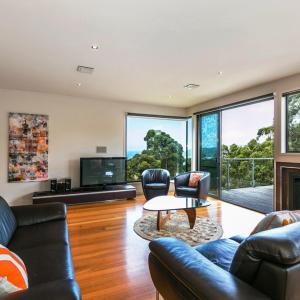 a living room with a couch and a table at LVista Lorne in Lorne