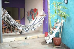 a hammock sitting on the side of a building at Casa Caballito in León