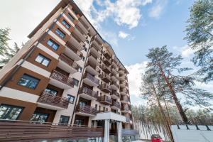 a building with balconies on the side of it at Apartment Imperial in Vila Pekovic Green in Zlatibor