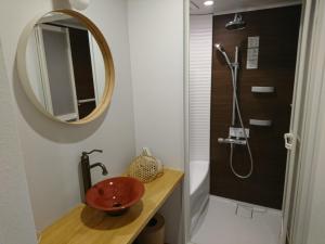 a bathroom with a red sink and a shower at Miyajima Shiro in Miyajima