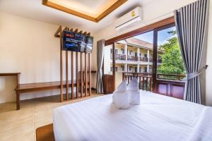 a bedroom with a bed and a large window at Wyh Hotels in Koh Tao