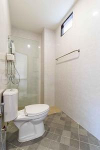 a white bathroom with a toilet and a shower at Wyh Hotels in Ko Tao