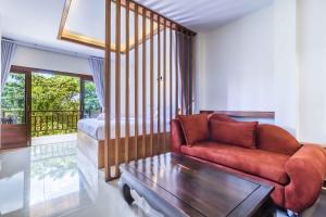 a living room with a couch and a bed at Wyh Hotels in Ko Tao