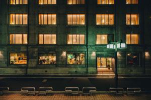 a large building with windows on the side of a street at Hotel K5 in Tokyo