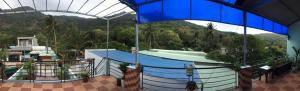a swimming pool in a building with a blue roof at Con Son Green Island in Con Dao