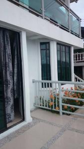 a house with windows and a balcony with flowers at Seribu 1 Homestay Single Room in Kundasang