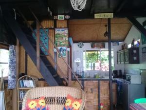 a kitchen with a staircase in a house at Fare Vahine Oviri - 1048DTO-MT in Uturoa