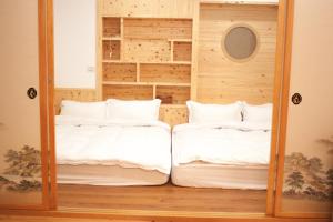 מיטה או מיטות בחדר ב-Yellow Mountain Homestay