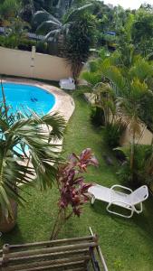 a view of a swimming pool with a white lounge chair next to it at Apartment Derningham in Trou aux Biches