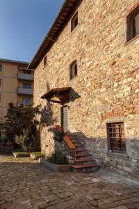 a brick building with stairs and an umbrella on it at Little Room - Camera indipendente nella Torre in Pontassieve