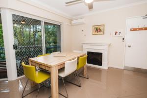 a kitchen with a table and chairs and a fire place at Sanctuary Lake Apartments in Gold Coast