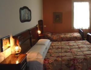 a bedroom with two beds and a table and a window at La Casa di Campagna in Reggio Emilia