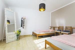 a bedroom with two beds and a mirror at SoulSurfcamp Portugal in Peniche