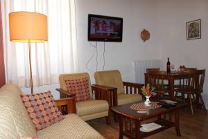 a living room with a couch and a table at ATRATSA Mountain Suites in Kalopanayiotis
