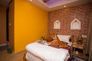 a bedroom with two beds with a tiger sitting on the bed at Blue Mountain Home Stay in Kathmandu
