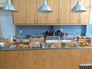 a kitchen with a counter top with bowls of food at CityZen Rooms Chios in Chios