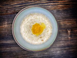 a bowl of oatmeal with an egg in it at Premier Alatau Hotel in Almaty