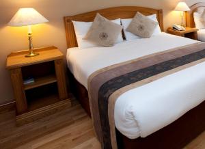 Postel nebo postele na pokoji v ubytování Majestic Hotel