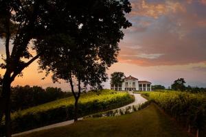 a house on a hill with a road in front at Villa Maria Vittoria in Nervesa della Battaglia +2 photos