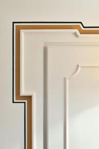 a white door with a black border on a wall at Splendido Mare, A Belmond Hotel, Portofino in Portofino