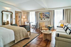 a hotel room with a bed and a living room at Splendido Mare, A Belmond Hotel, Portofino in Portofino