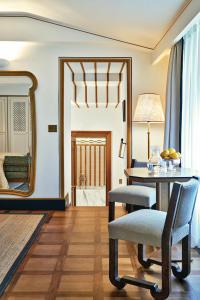 a living room with a table and a mirror at Splendido Mare, A Belmond Hotel, Portofino in Portofino