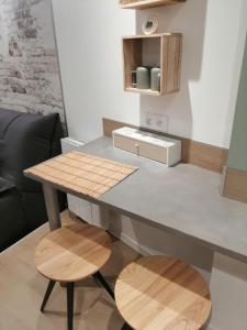 a kitchen with a table and two stools at Le cabanon in Méneslies