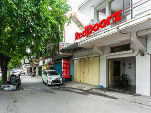 um edifício com um sinal vermelho na lateral em RedDoorz @ Urip Sumoharjo Solo em Surakarta