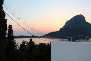 a view of a mountain and a river at sunset at Tatsis Apartments in Masouri