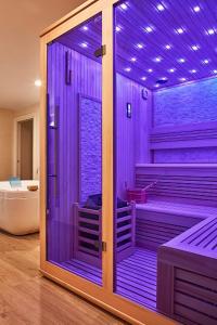 a bathroom with a purple shower with a tub at Villa Maria Vittoria in Nervesa della Battaglia
