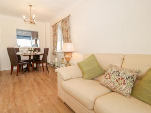 a living room with a couch and a table at Bay View House in Colwyn Bay
