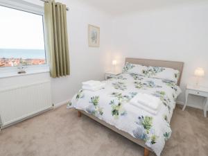 a bedroom with a bed and a window at Bay View House in Colwyn Bay