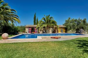 a swimming pool in front of a house at Finca La Salve in Pollença