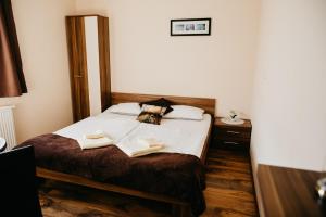 a bedroom with a bed with two towels on it at Apartments-rooms Vogrinec in Ptuj
