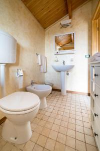 a bathroom with a toilet and a sink at Chalet Tenuta Lacco in Furnari
