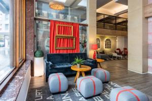 a lobby with a couch and a table and chairs at Hotel San Sebastián Orly, Affiliated by Meliá in Donostia-San Sebastián