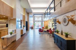 an office lobby with a reception desk and chairs at Hotel San Sebastián Orly, Affiliated by Meliá in Donostia-San Sebastián