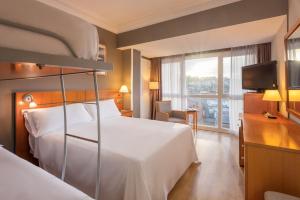 a hotel room with a bed and a television at Hotel San Sebastián Orly, Affiliated by Meliá in Donostia-San Sebastián