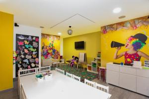 a kindergarten classroom with a clown wig on the wall at Gloria Rooms in Požega